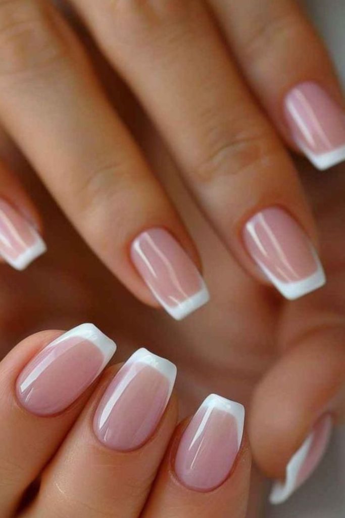 White translucent tips on nude nails.