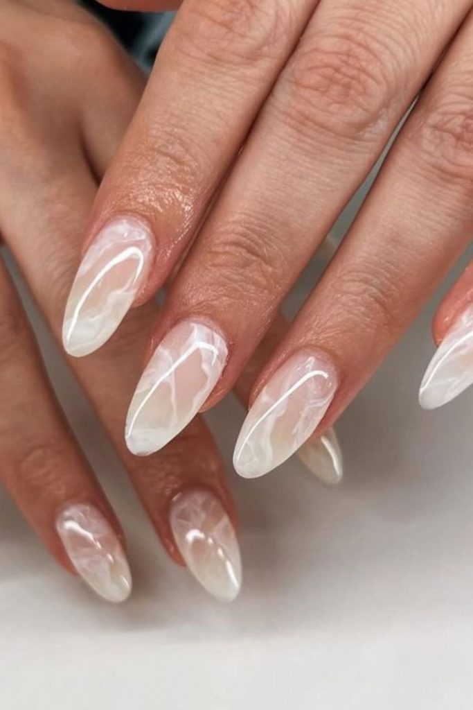 Milky nails with swirling marble patterns