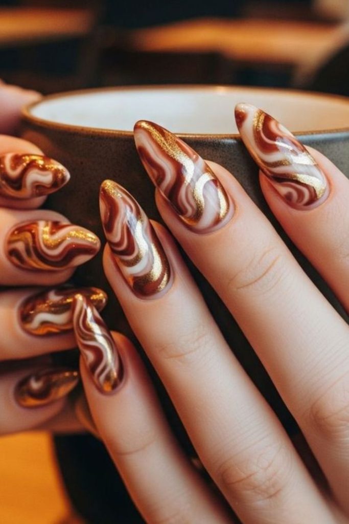 Chocolate brown nails with caramel swirls.