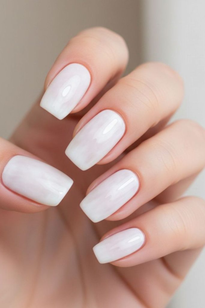 Cool-toned milky nails crisp finish.