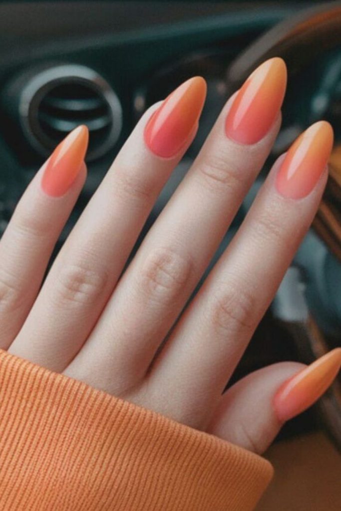 Warm coral gradient nails with glow