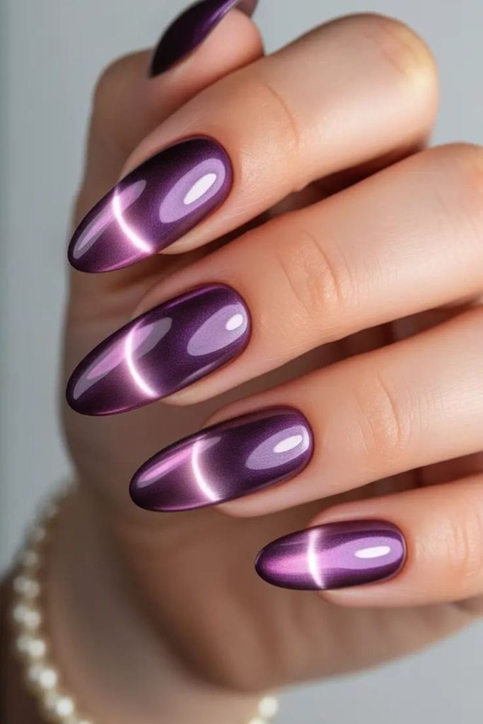 Violet cosmic cat eye manicure