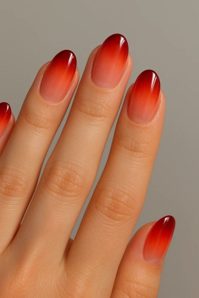 Molten orange nails with golden flecks