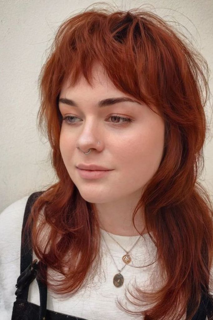 Red-orange jagged layered wolf cut.