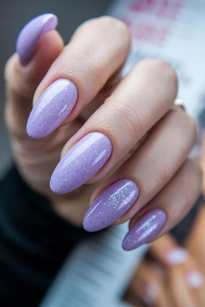 Pale lilac frosted nails with sparkle.