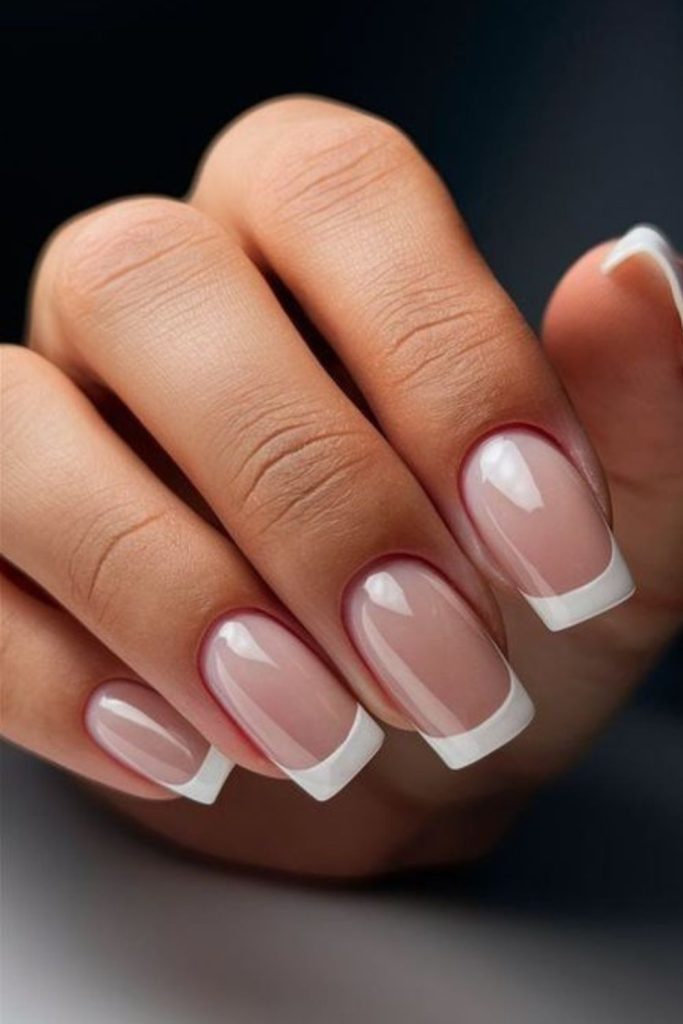 Soft shimmering white square French nails.