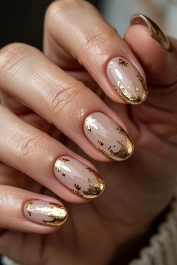 Champagne nails scattered with gold flecks