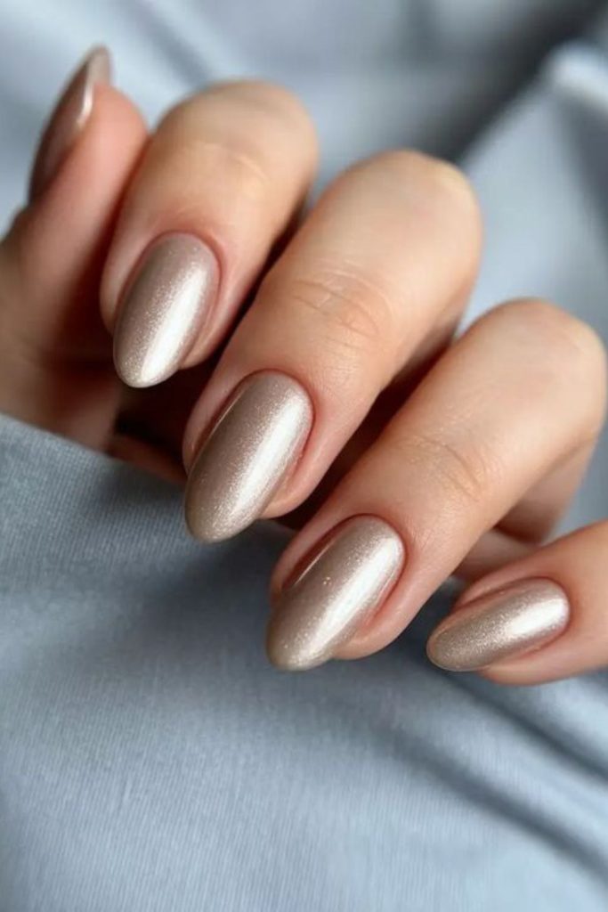 Gold almond nails with regal shimmer.