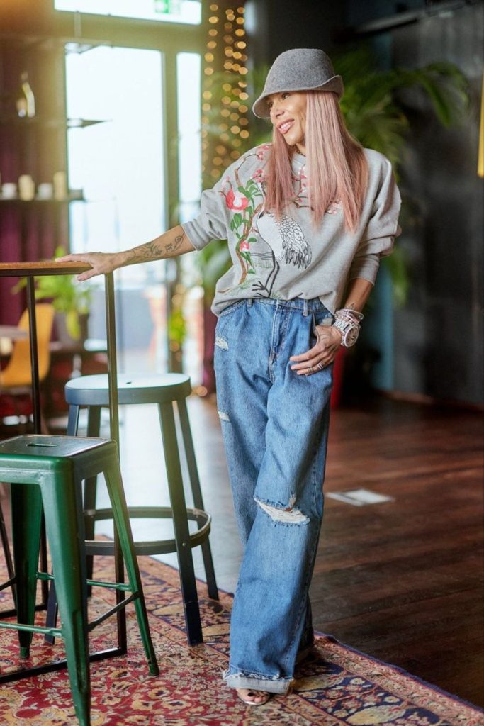 Oversized graffiti shirt paired with distressed jeans