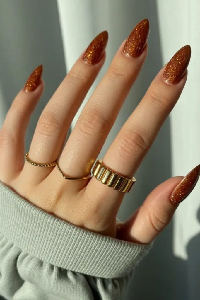 Golden amber nails with sunlit shimmer.