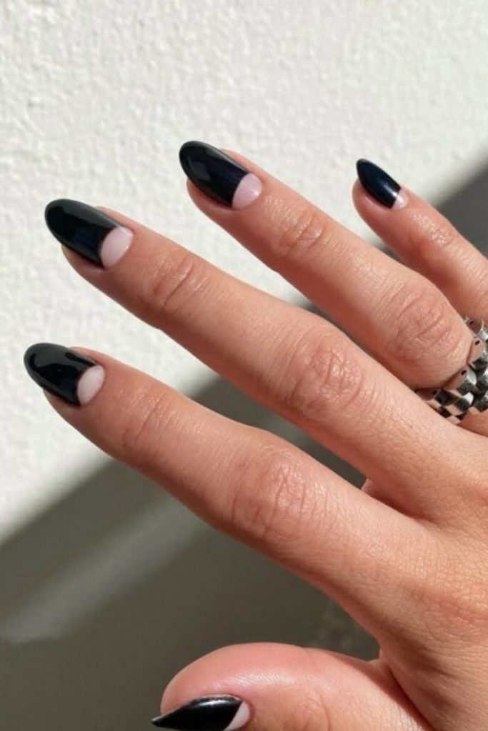 Half-moon design on black nails