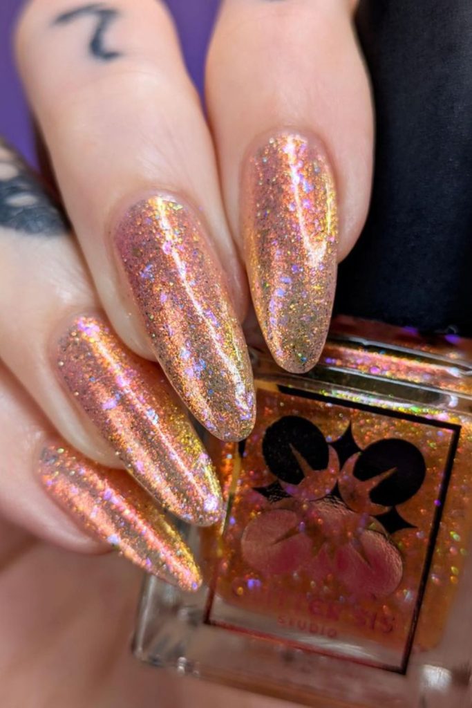 Coral nails with holographic exploding glitter shards.