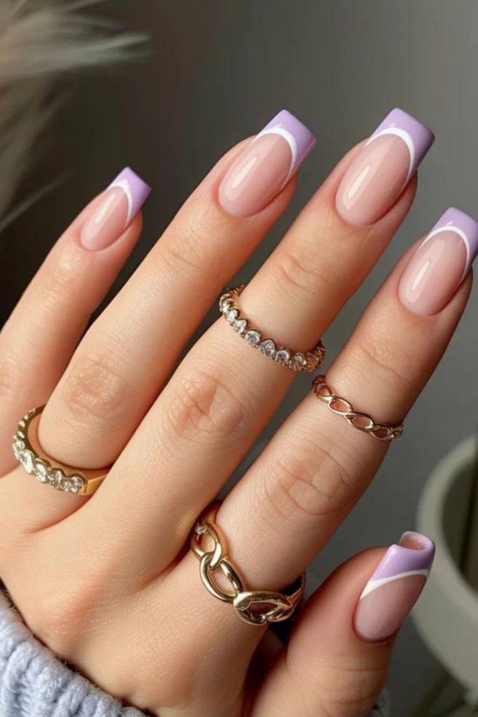 Lilac arcs on muted nude nails.