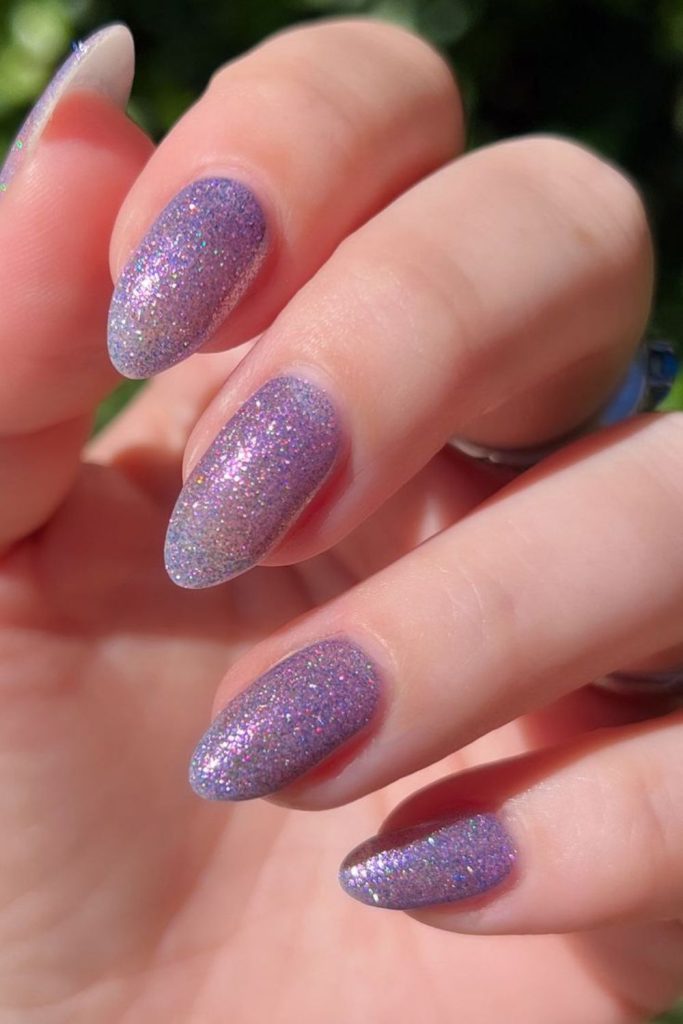 Lavender nails with holographic glitter flecks.