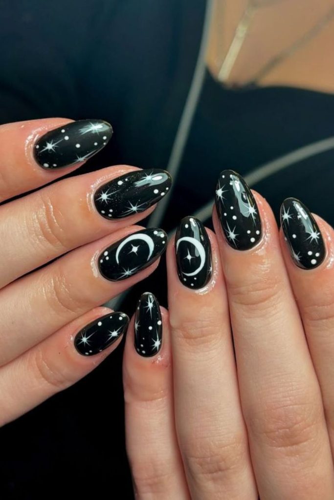 Black and silver celestial nail design