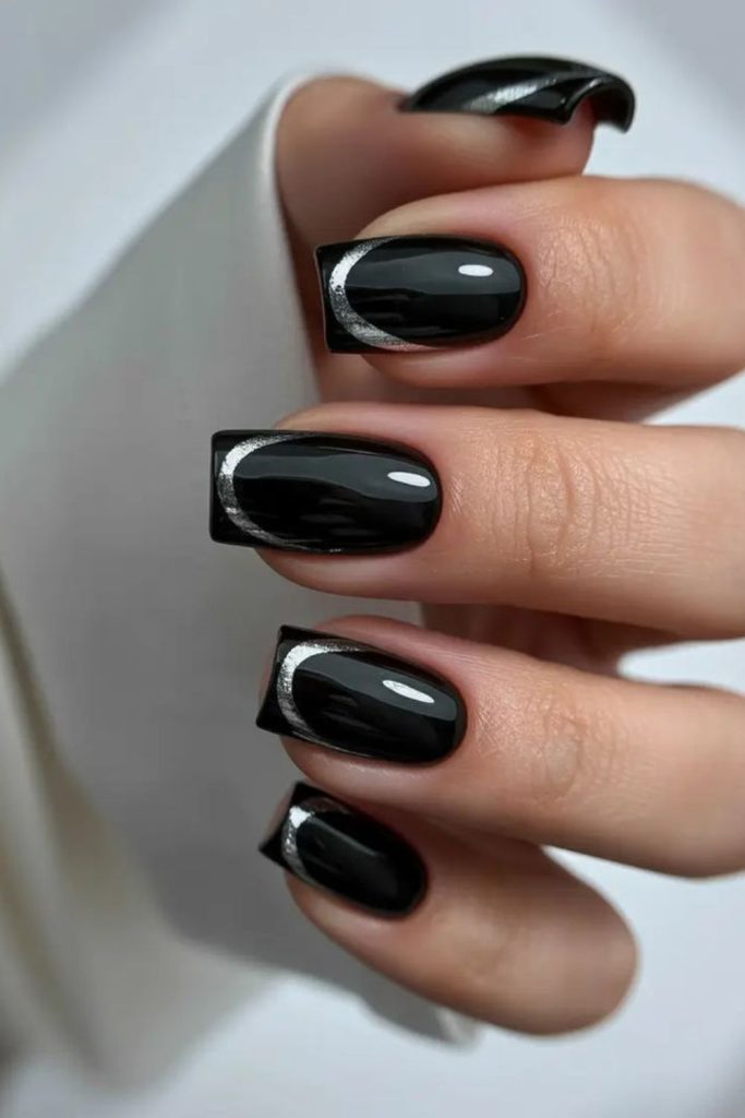 Tiny abstract squiggles on black nails