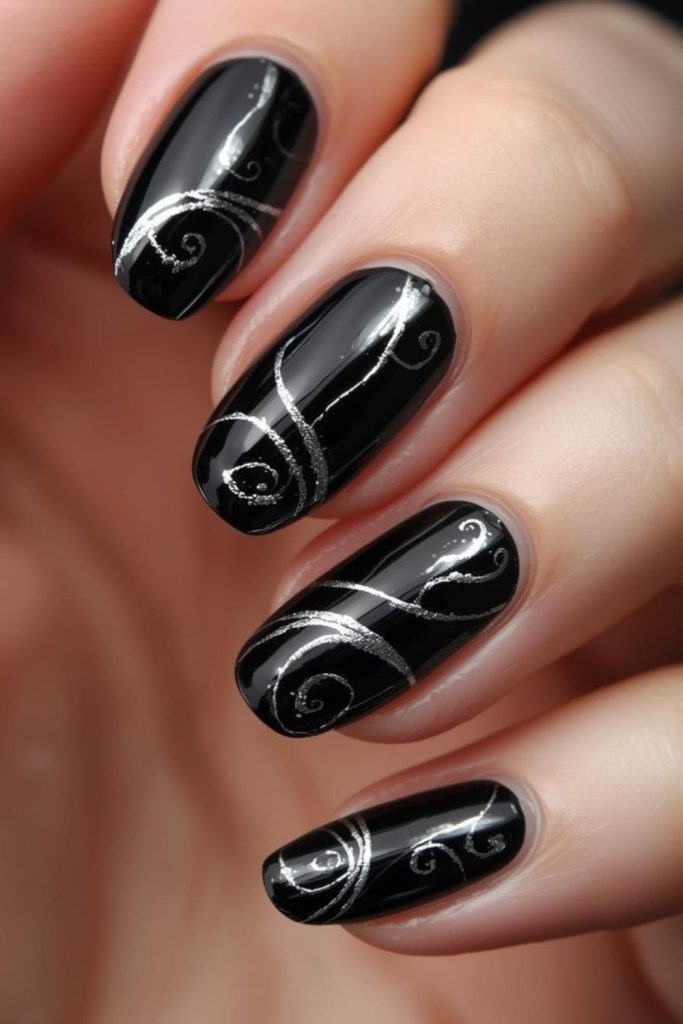 Black nails with swirling silver glitter tornado.