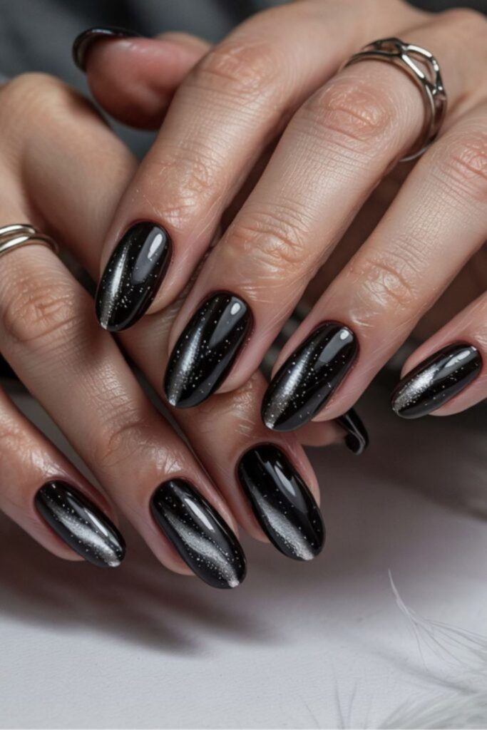 Glossy black nails with subtle shimmer