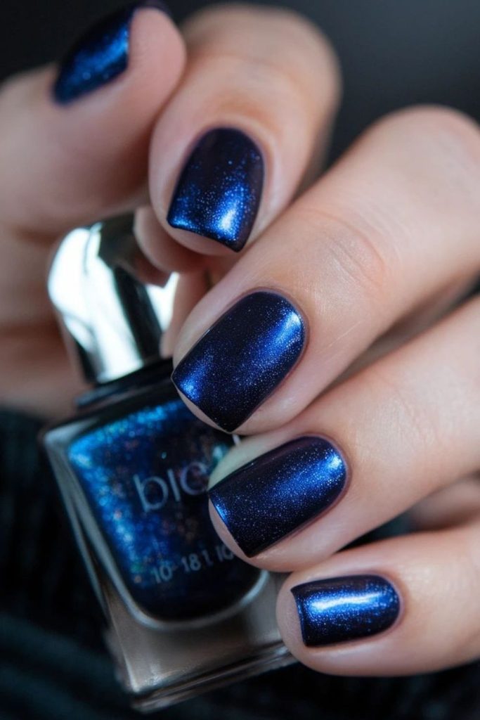 Deep navy nails with reflective shimmer
