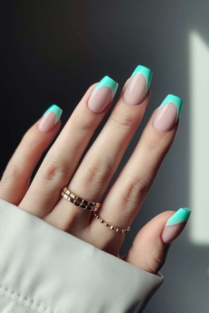 Pastel mint tips on cream nails.