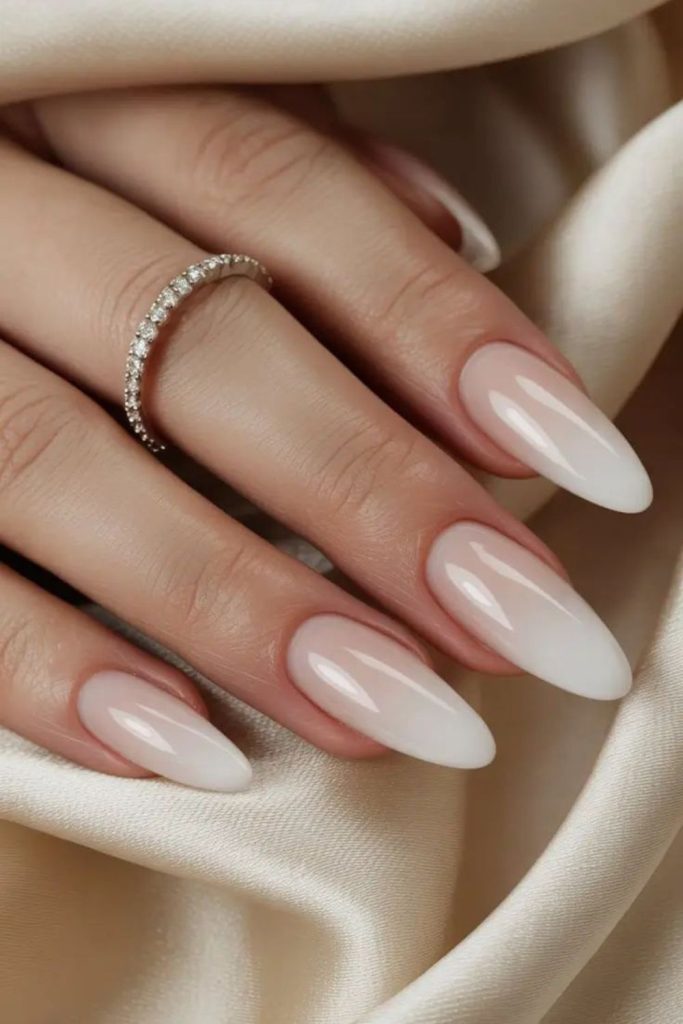 Glossy moon-inspired soft milky nails.