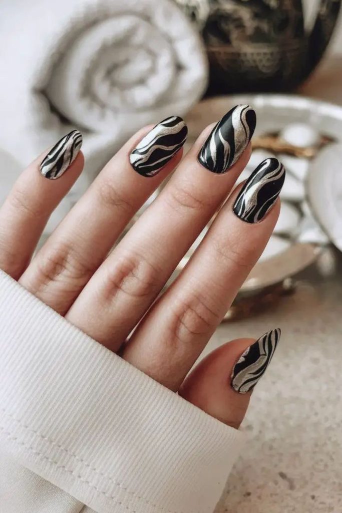 Wavy lines across matte black nails