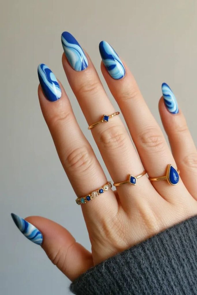 Deep blue swirling ocean nails