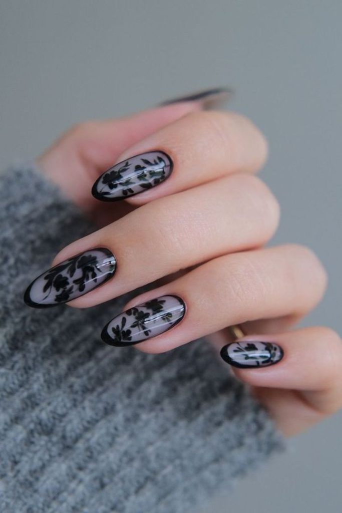 Black nails with delicate lace patterns.