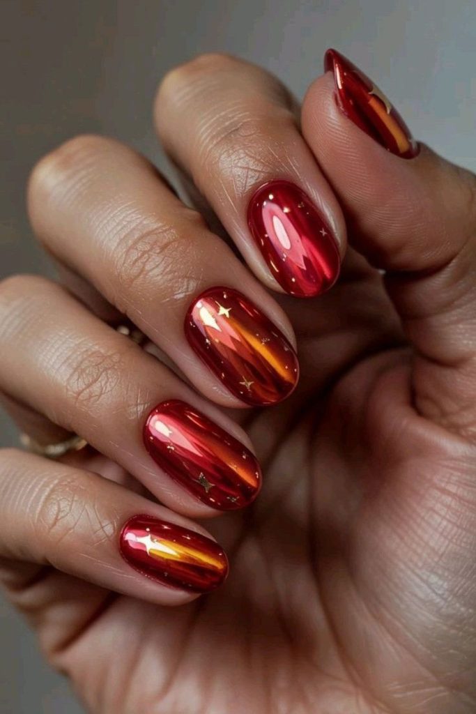 Ruby red nails with orange gold streaks.