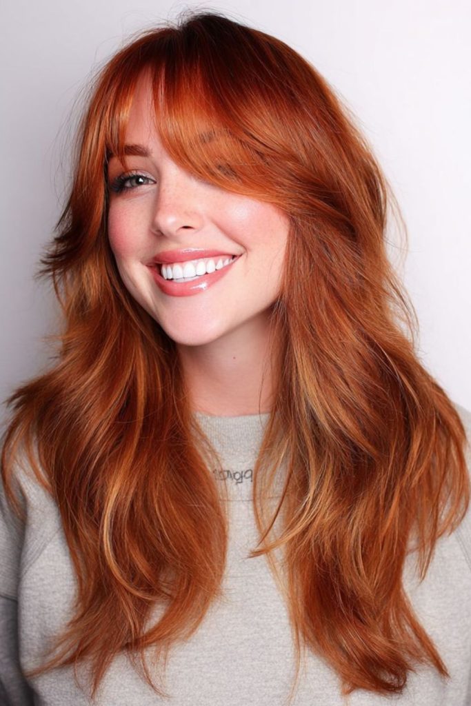 Amber-tinted micro bangs with chestnut length