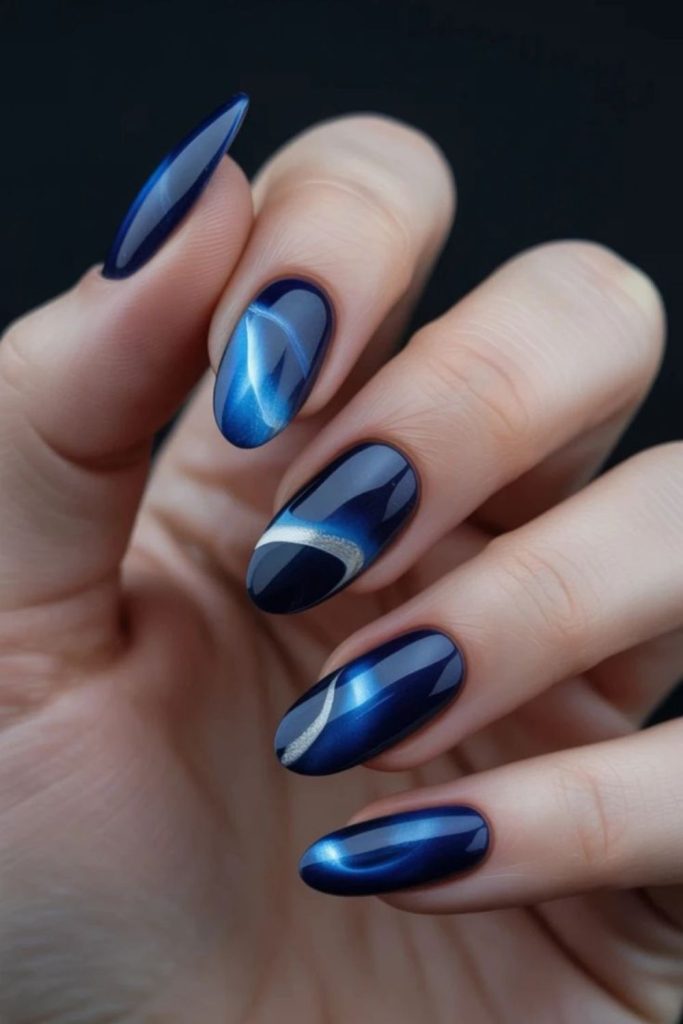 Sapphire nails with silver geometric facets.