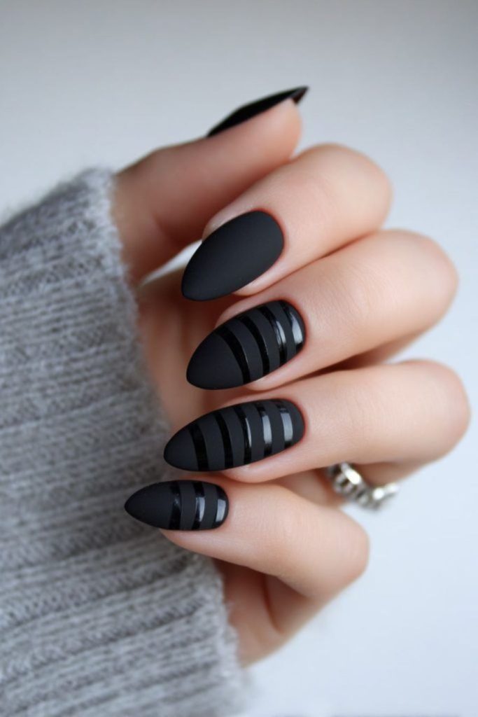 Diagonal scratches across black nail surface