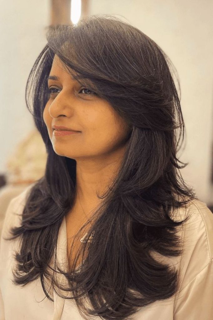 Long side-swept wisps masking cheek fullness