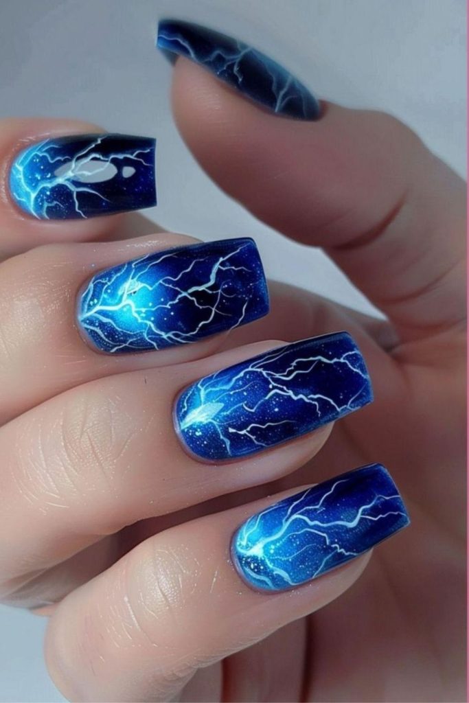 Stormy blue nails with lightning streaks