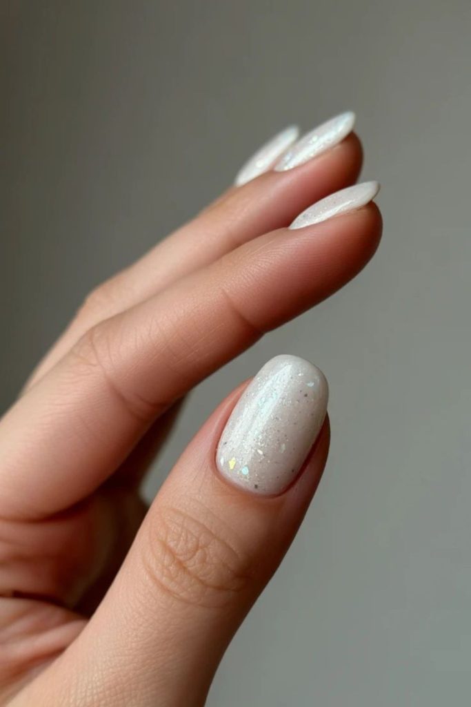 Milky nails with sparse glitter sparkle