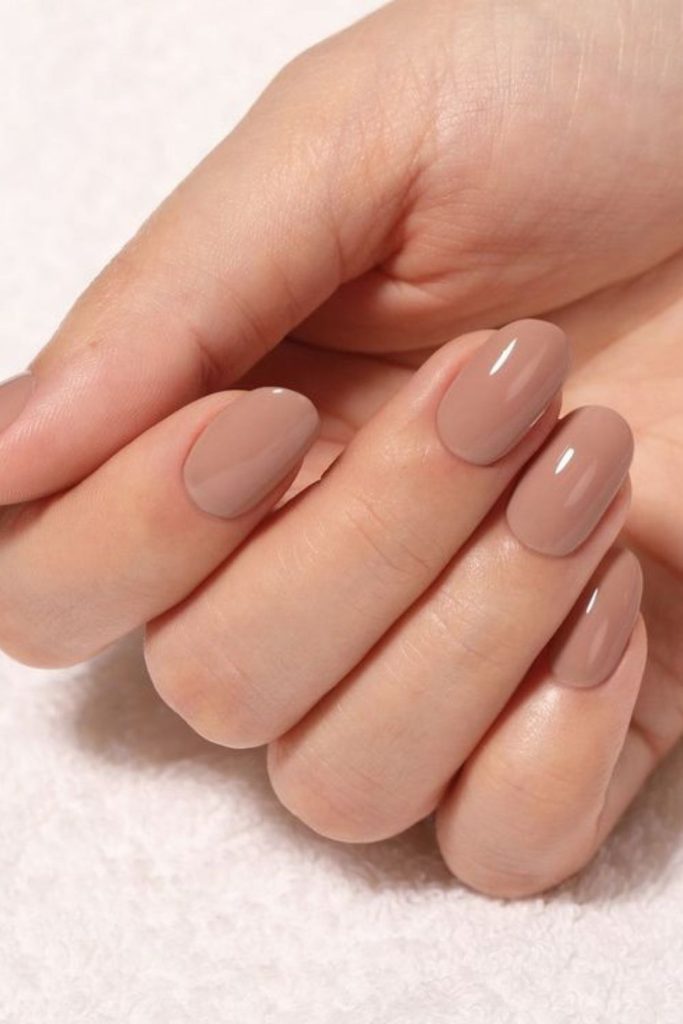 Smoky beige modern nude nails.