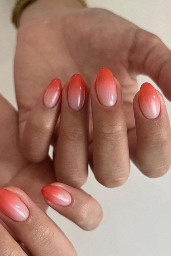 Tangerine fading tips on nails.