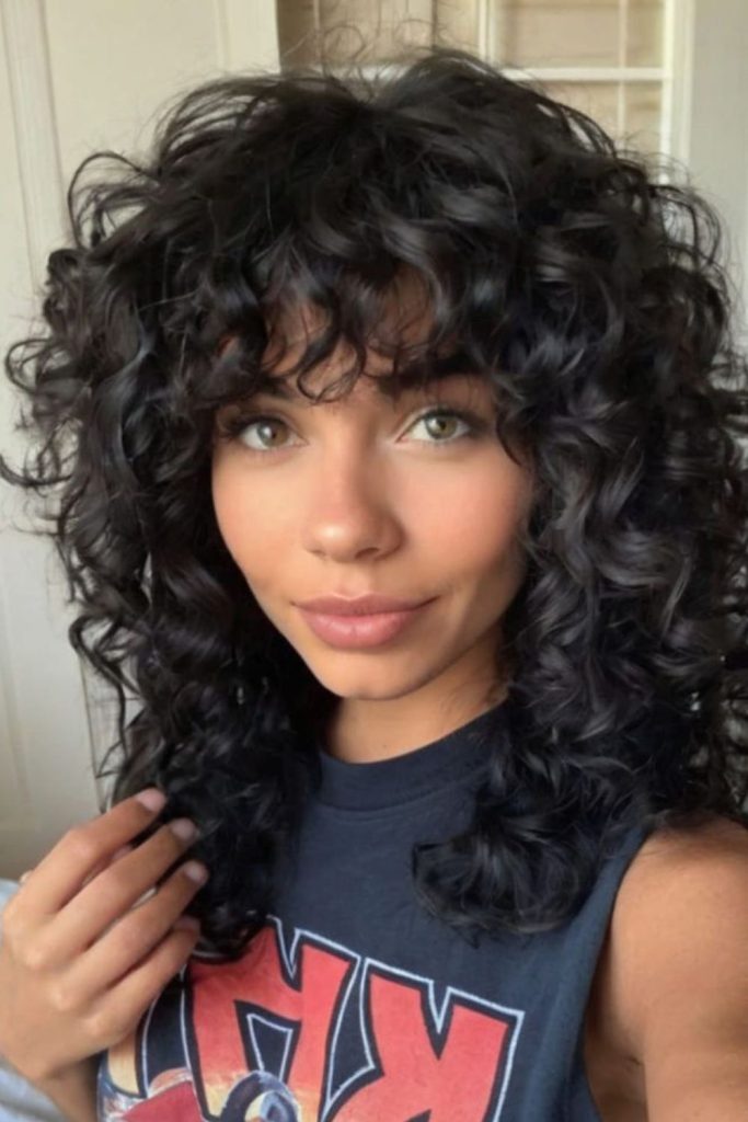 Deep evening curls with magnetic volume.