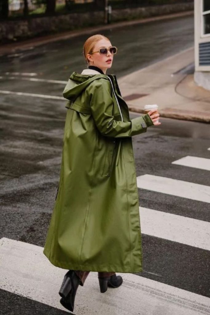 PVC raincoat over muted minimal layers