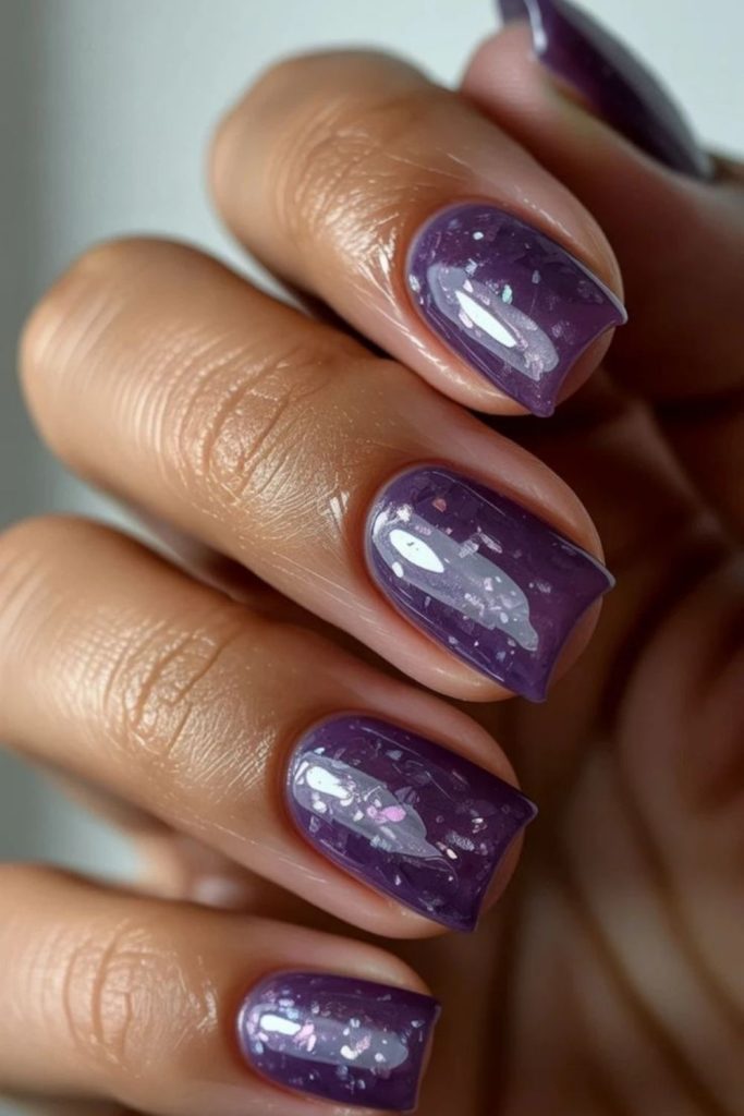 Violet nails with silver dusk streaks.