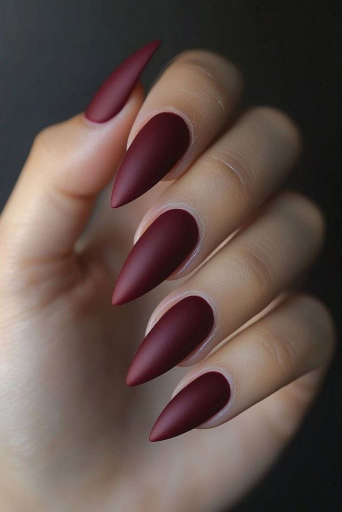 Deep red matte nails with copper