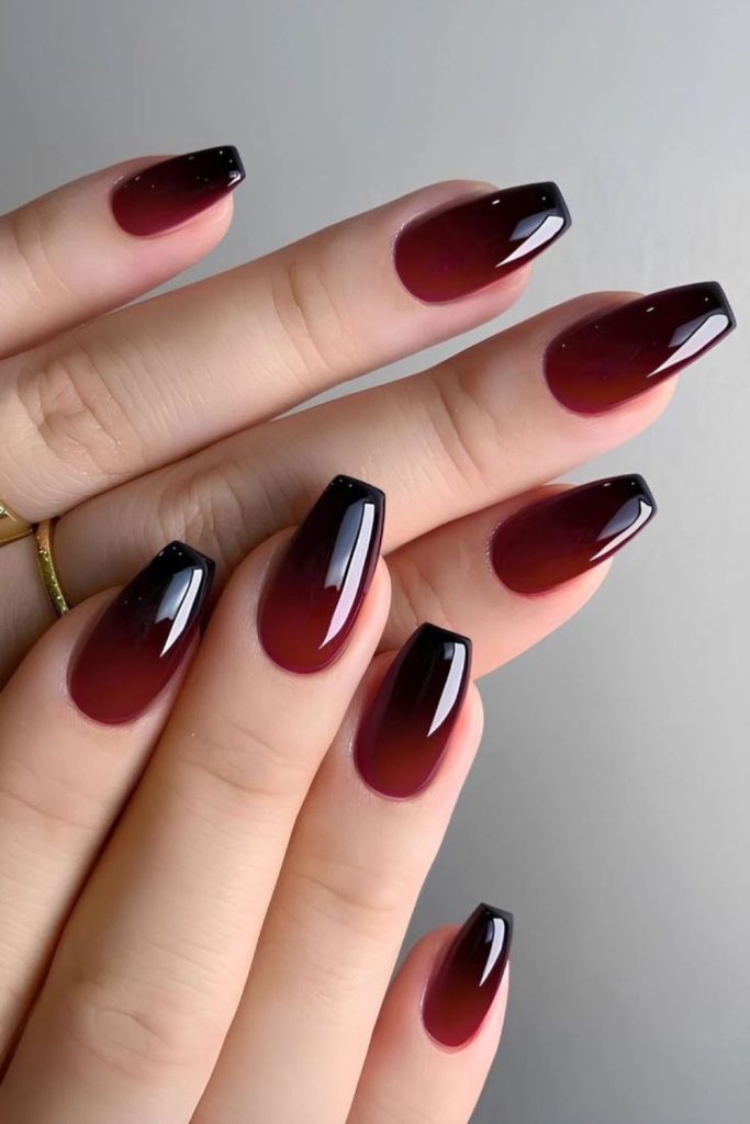 Crimson nails with matte black overlay.