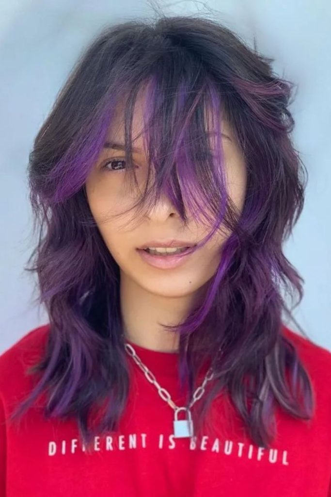 Purple-black textured wolf cut dramatic.