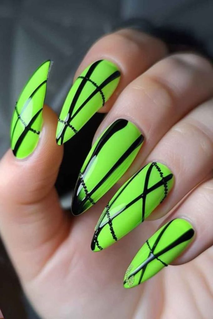 Neon green nails with jagged accents.