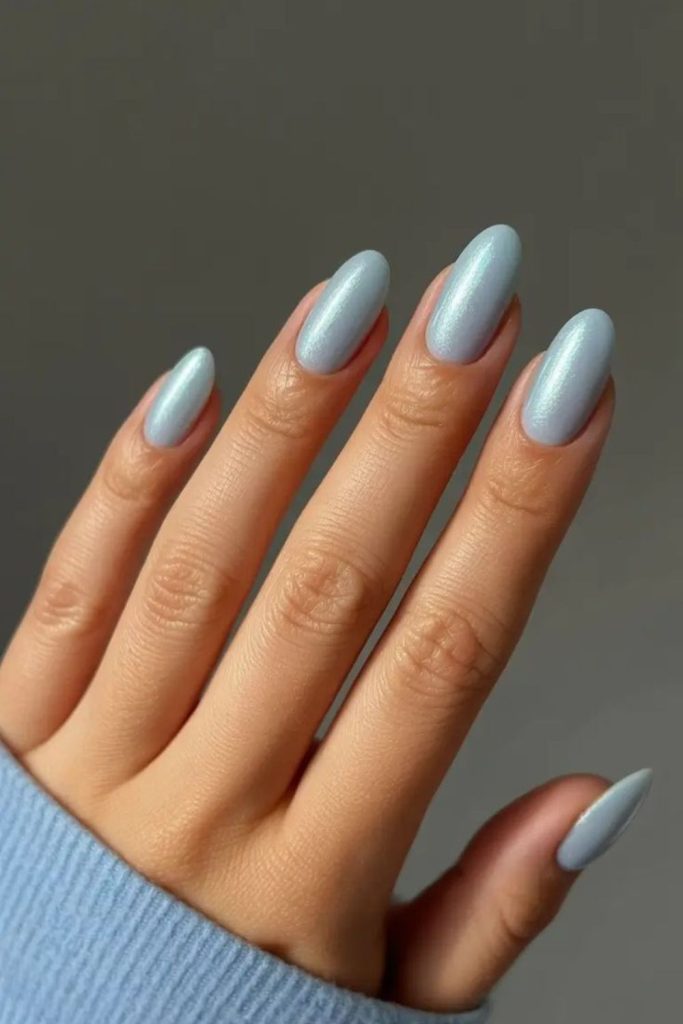 Icy blue shimmering nails, frozen glow.