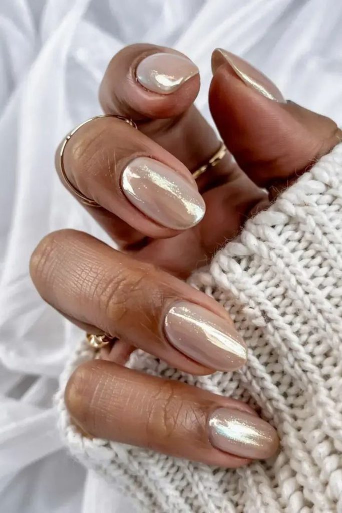 Nude almond nails with muted gold shimmer