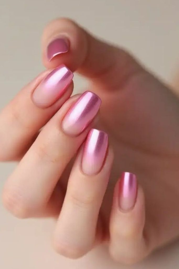 Pastel pink nails with iridescent shimmer.