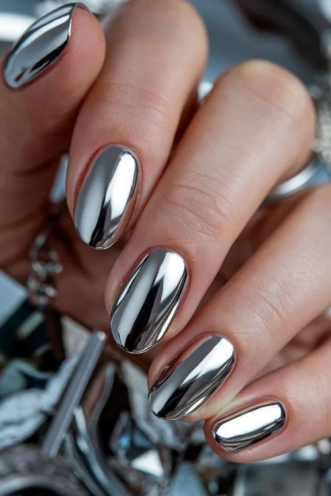 Mirror chrome nails with reflective surfaces.