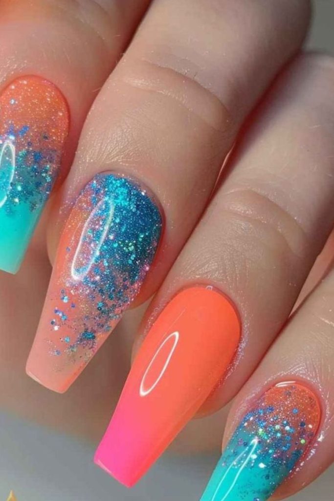 Coral and aqua nails with shimmer.