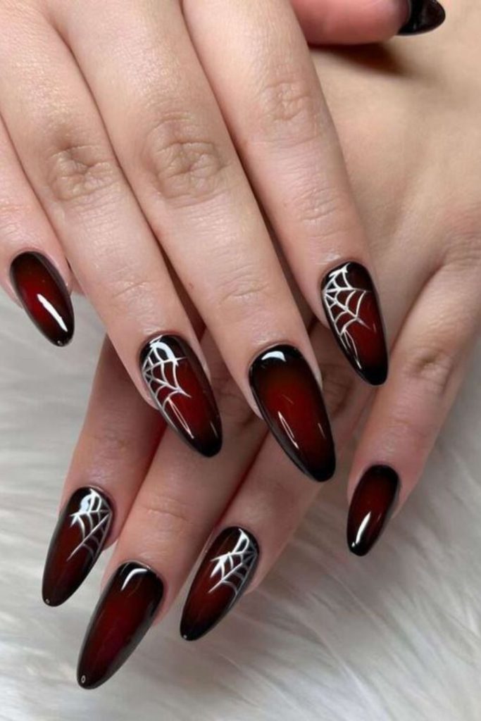 Black nails with red spiderweb hearts